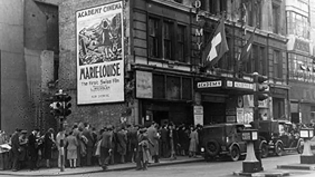 archival image academy cinema with theatre goers outside black and white