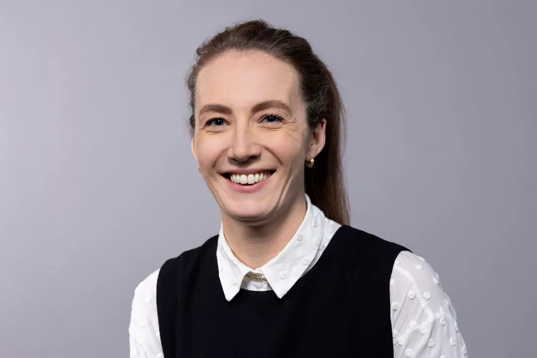Portrait of woman smiling in white shirt and black top