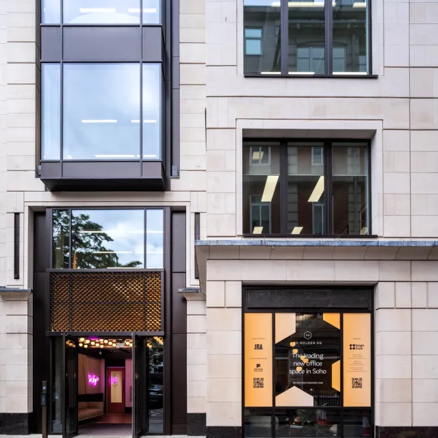 Bronze doorway on beige stone office building
