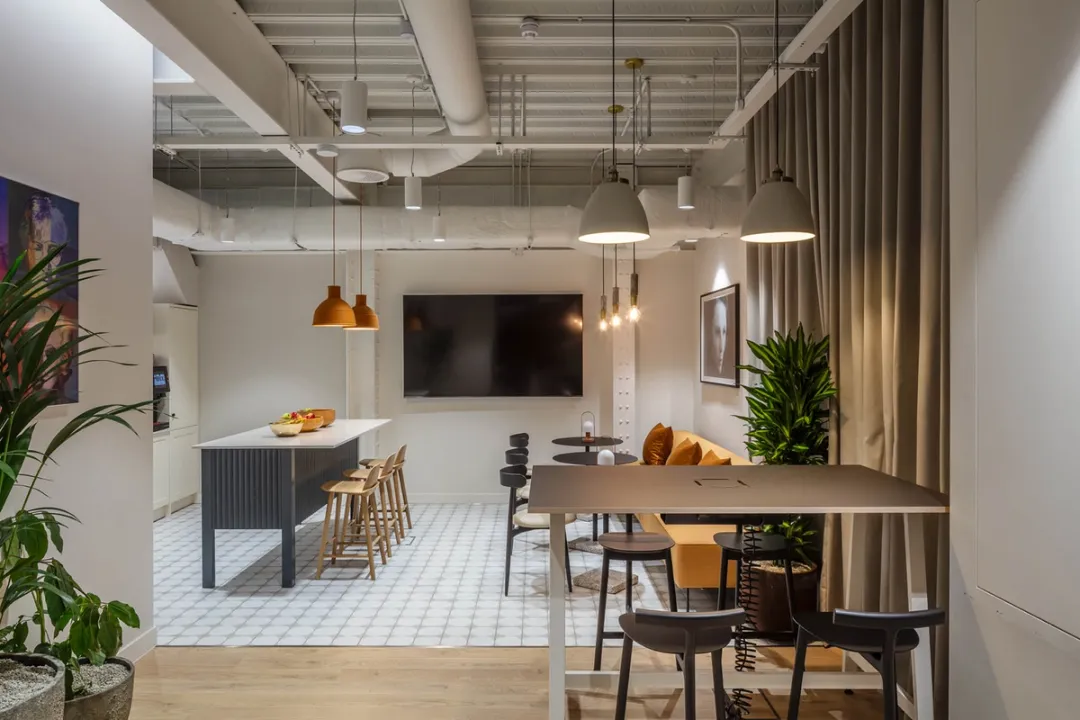Tables and chairs arranged as break out spaces in a basement