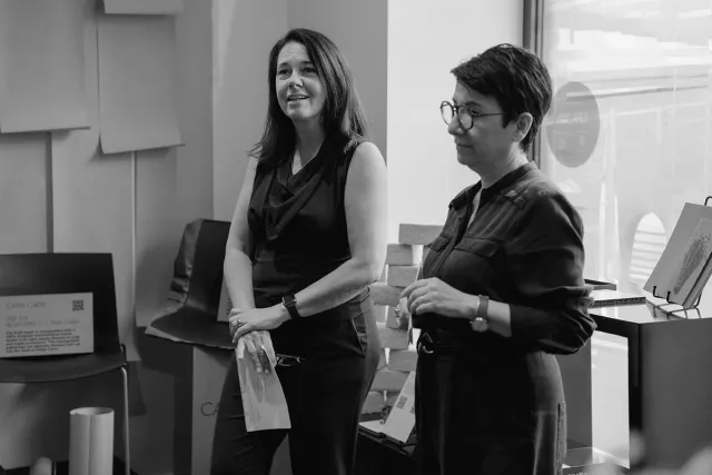 two people standing giving a talk