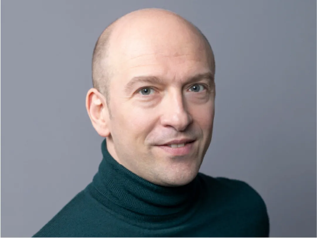 Portrait of person in dark green polo neck top