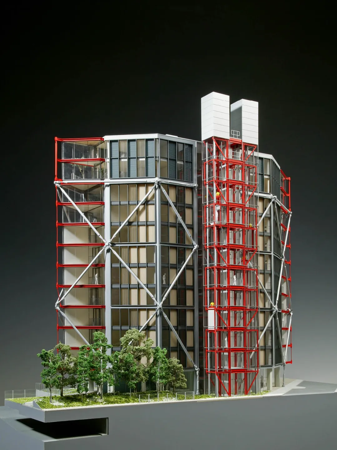 A model of a glass residential shower with red and silver external cross bracing