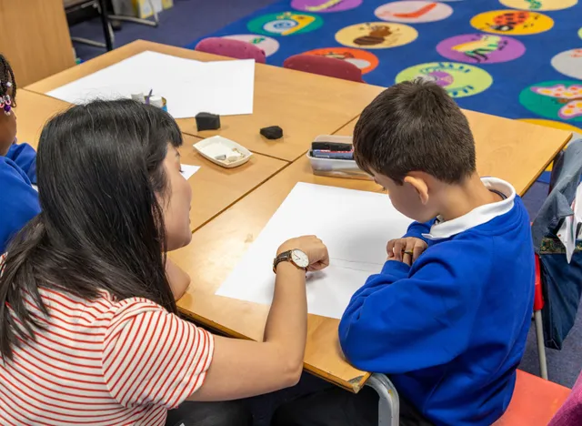 Sophia Yu helping year 2 pupil with drawing