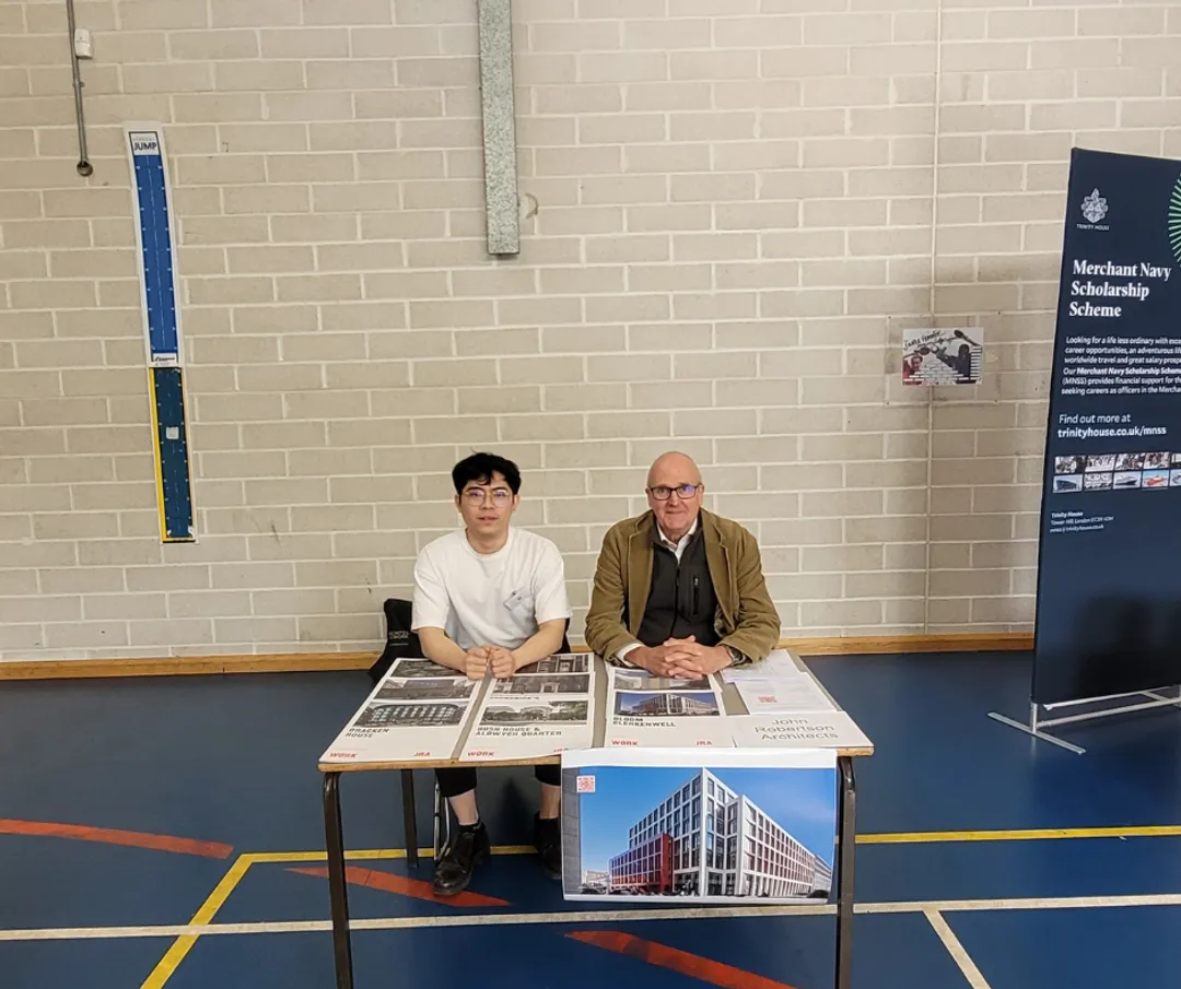 Two architects at a desk at a career fair