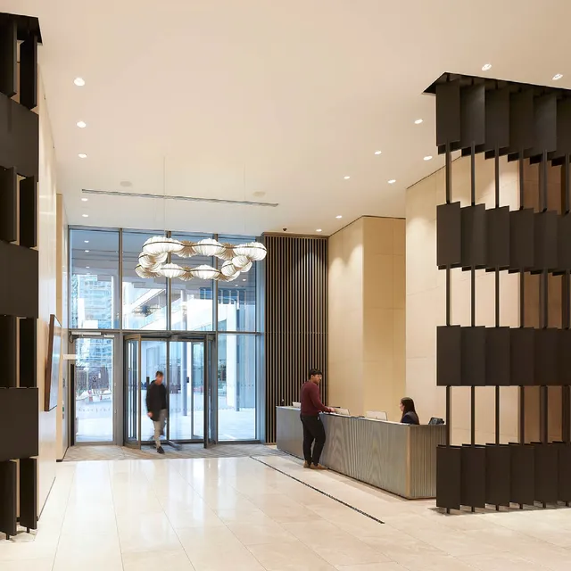 A double height reception with sculptural screens and lighting