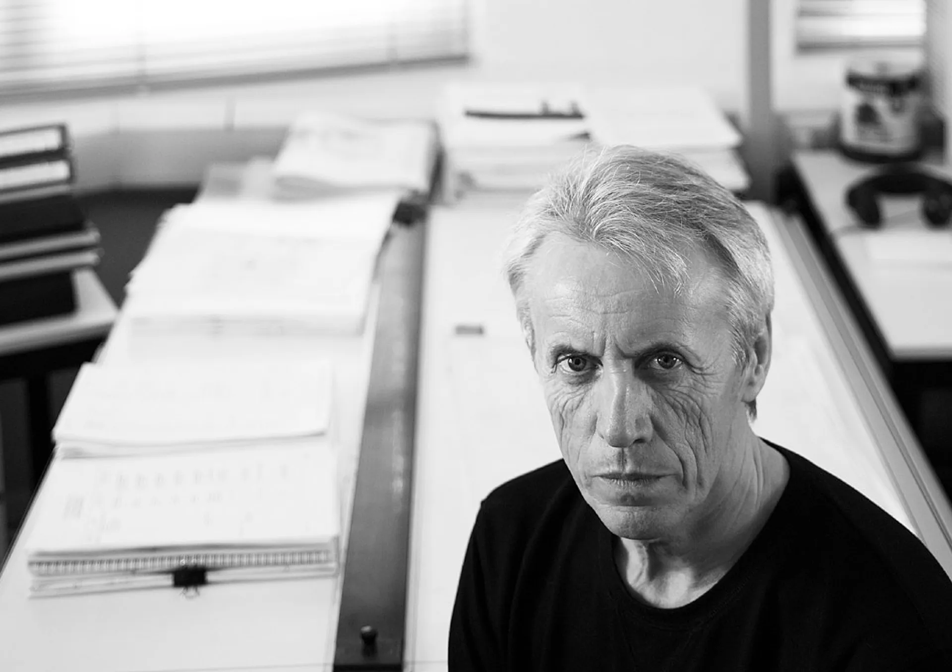 Portrait of Alan Rafter-Phillips against a desk with plans