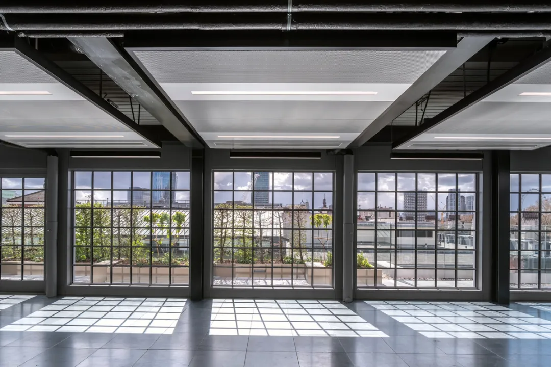 windows overlooking balcony from inside empty office space
