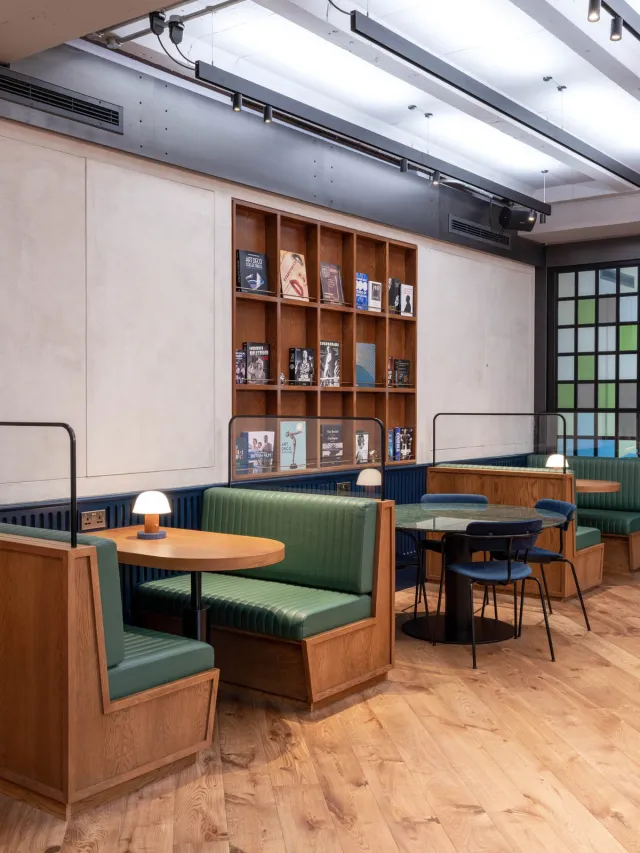 Green leather booth seats with shelving behind