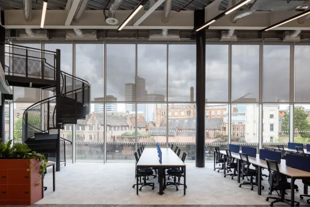 Co-working hot desks next to a large window