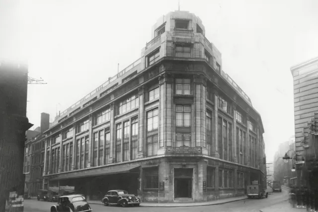 black and white historical image of building in corner