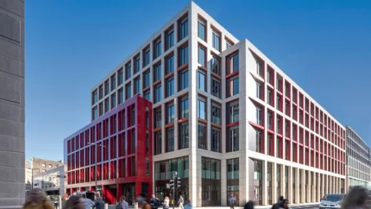 Three quarter view of Bloom Farringdon building with blurred people crossing the road
