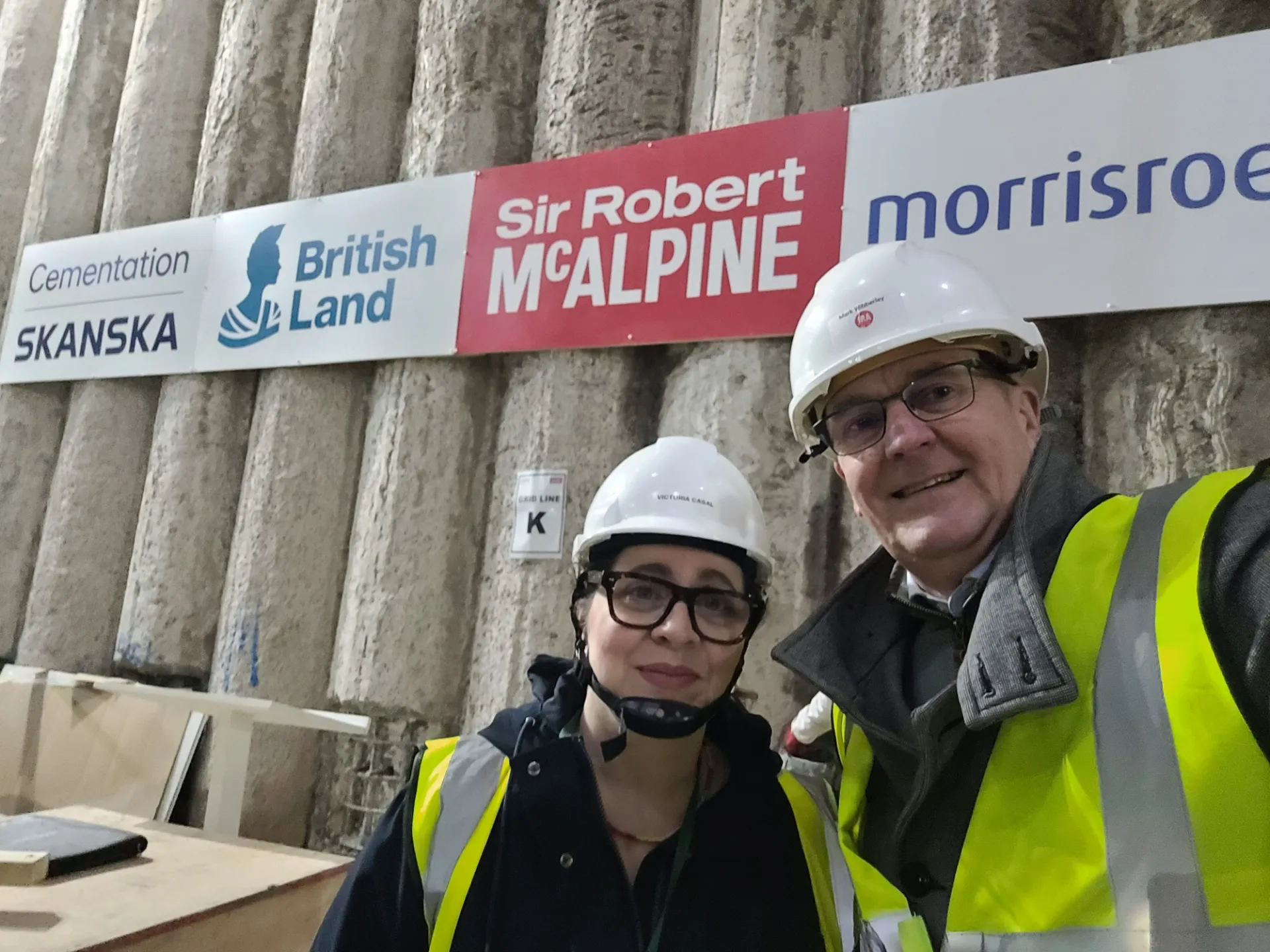 two people on site  of building under construction