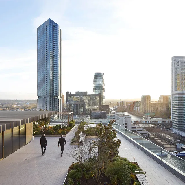 Two people walk on a landscape roof terrace