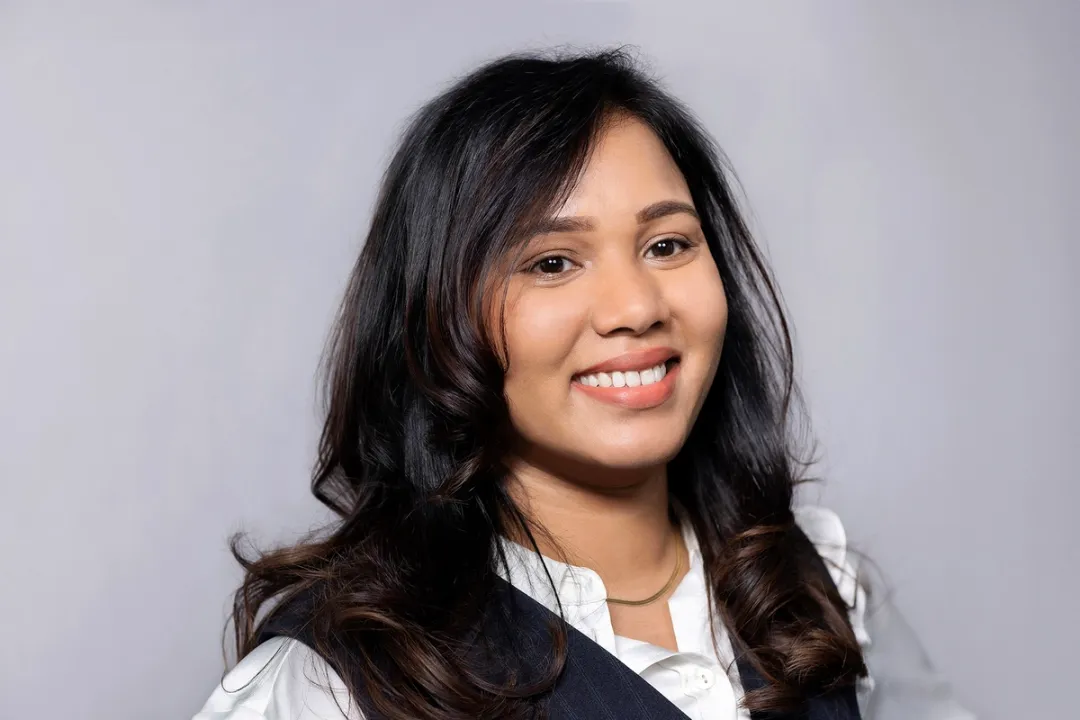 Portrait of smiling woman in white shirt and black top