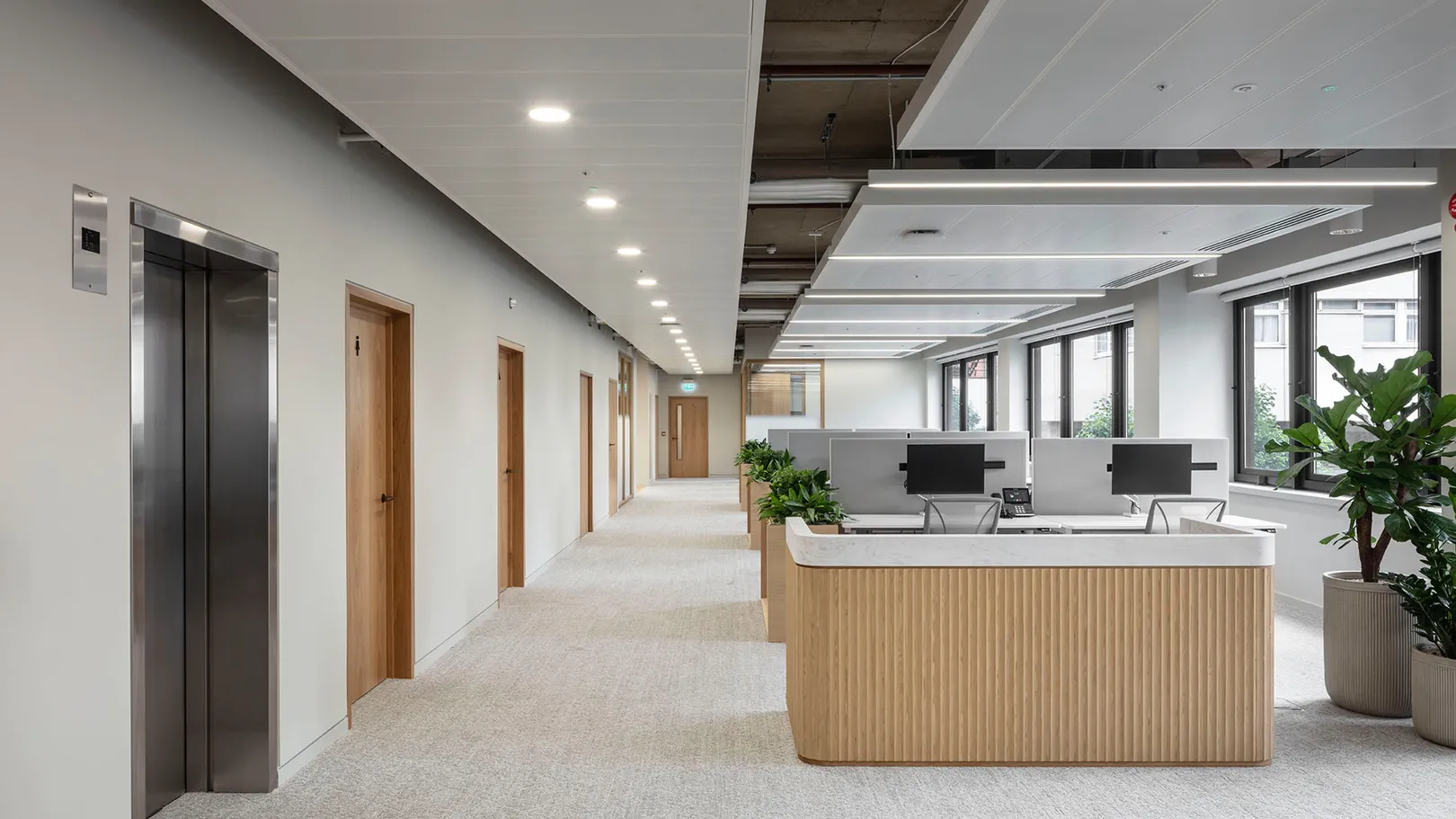 Long office with reception desk in the foreground 