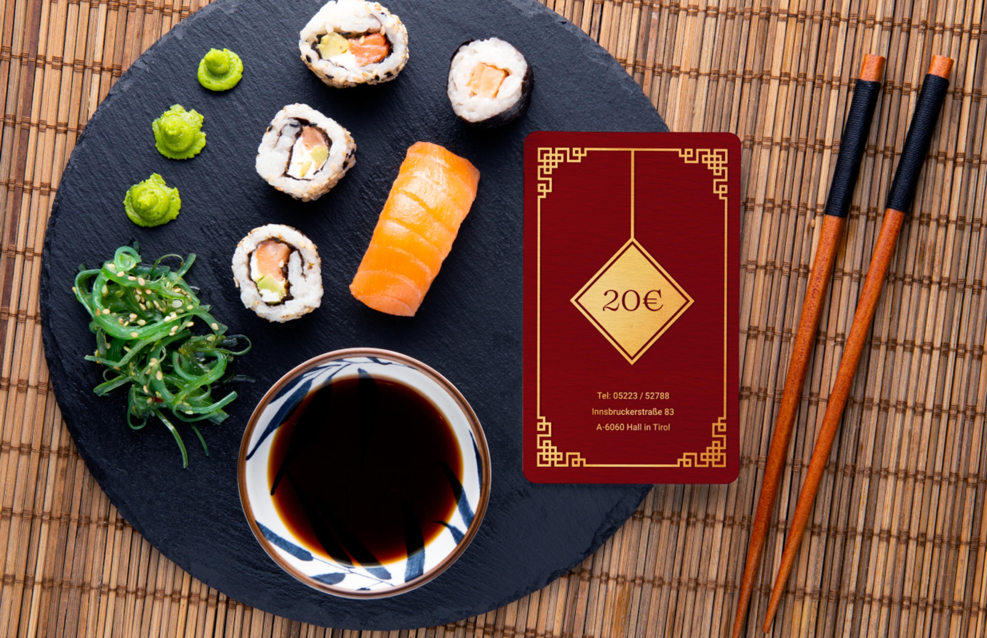 Exklusiver Geschenkgutschein des Kilin Restaurants im luxuriösen Design mit Goldprägung und asiatischen Mustern, stilvoll arrangiert mit Sushi, Algensalat und Wasabi auf einer Schieferplatte. Hochwertiges Branding für Premium-Gastronomie mit edler Farbgestaltung und durchdachter Markenstrategie. Konzipiert von Unerwartet Branding und Design OG aus Graz, Österreich.