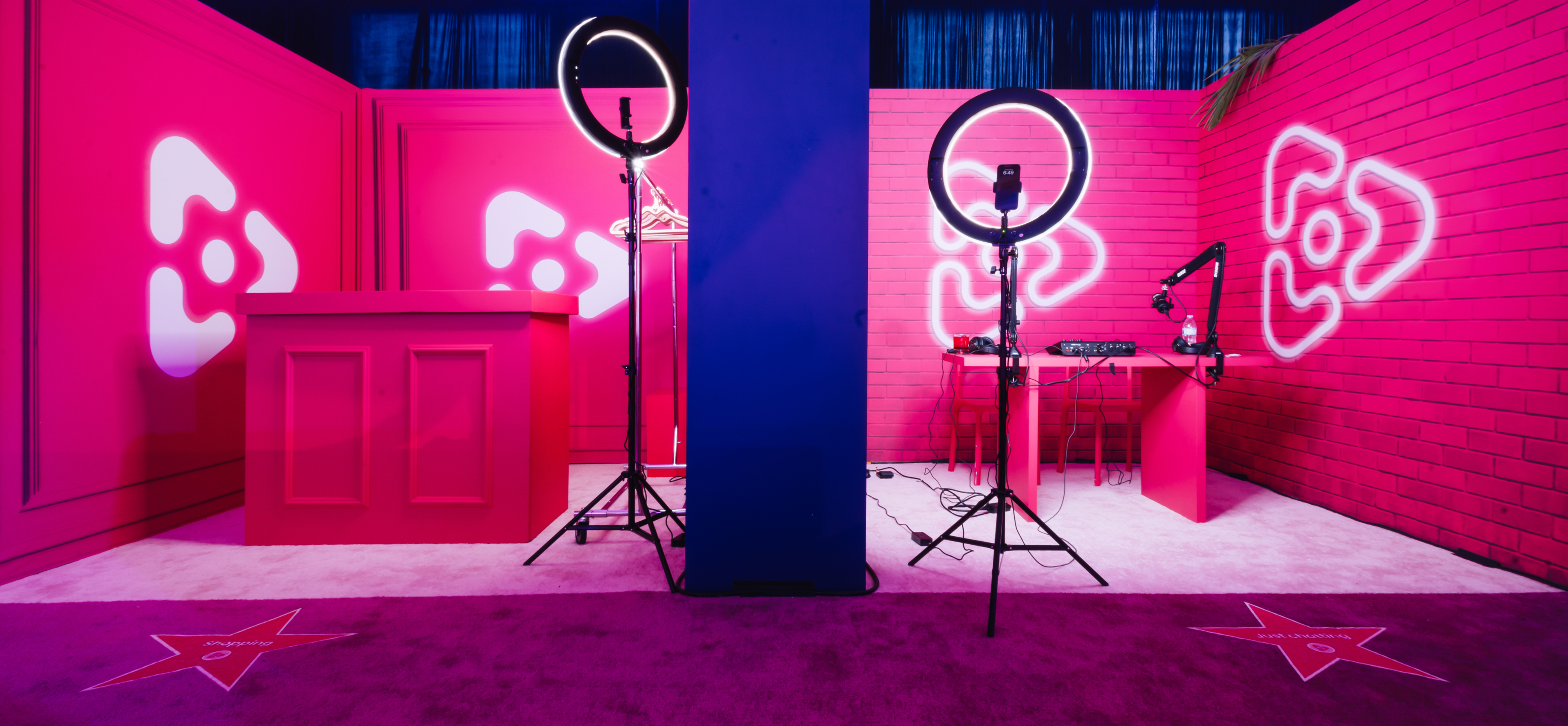 Foto: vinivia, bfa, jorgemezaphotos Vinivia Streaming-Lounge: Auffälliges pinkes Set-Design mit Ringlichtern, Mikrofonen und Branding-Logos – Unerwartet Design