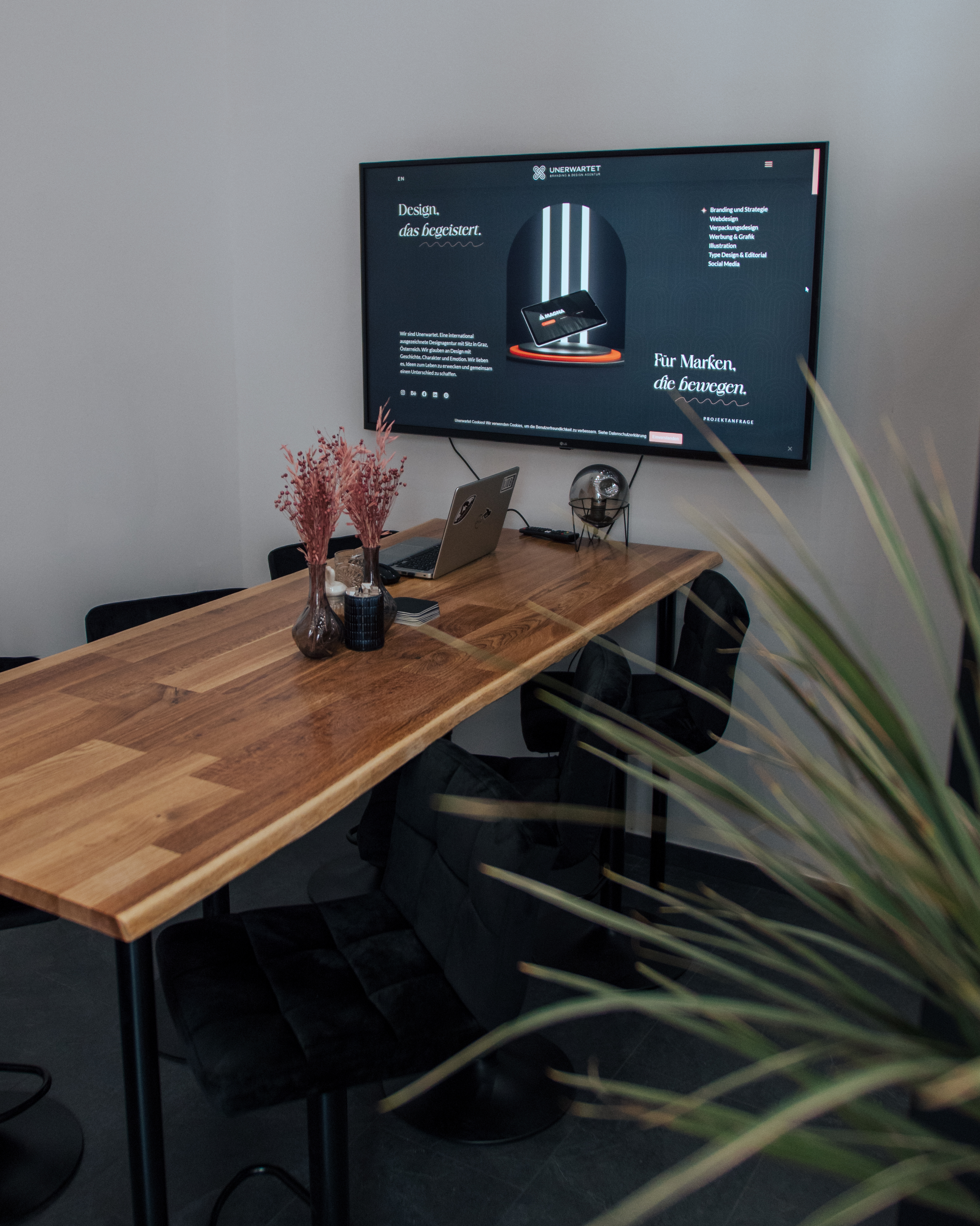 Ijob Brandstätter Die alte Unerwartet Design Webseite auf dem großen Bildschirm. Meetingsbereich für Kundenbesprechungen in dem Unerwartet Design Office in der Belgiergasse 16, 8020 Graz, Östtereich.