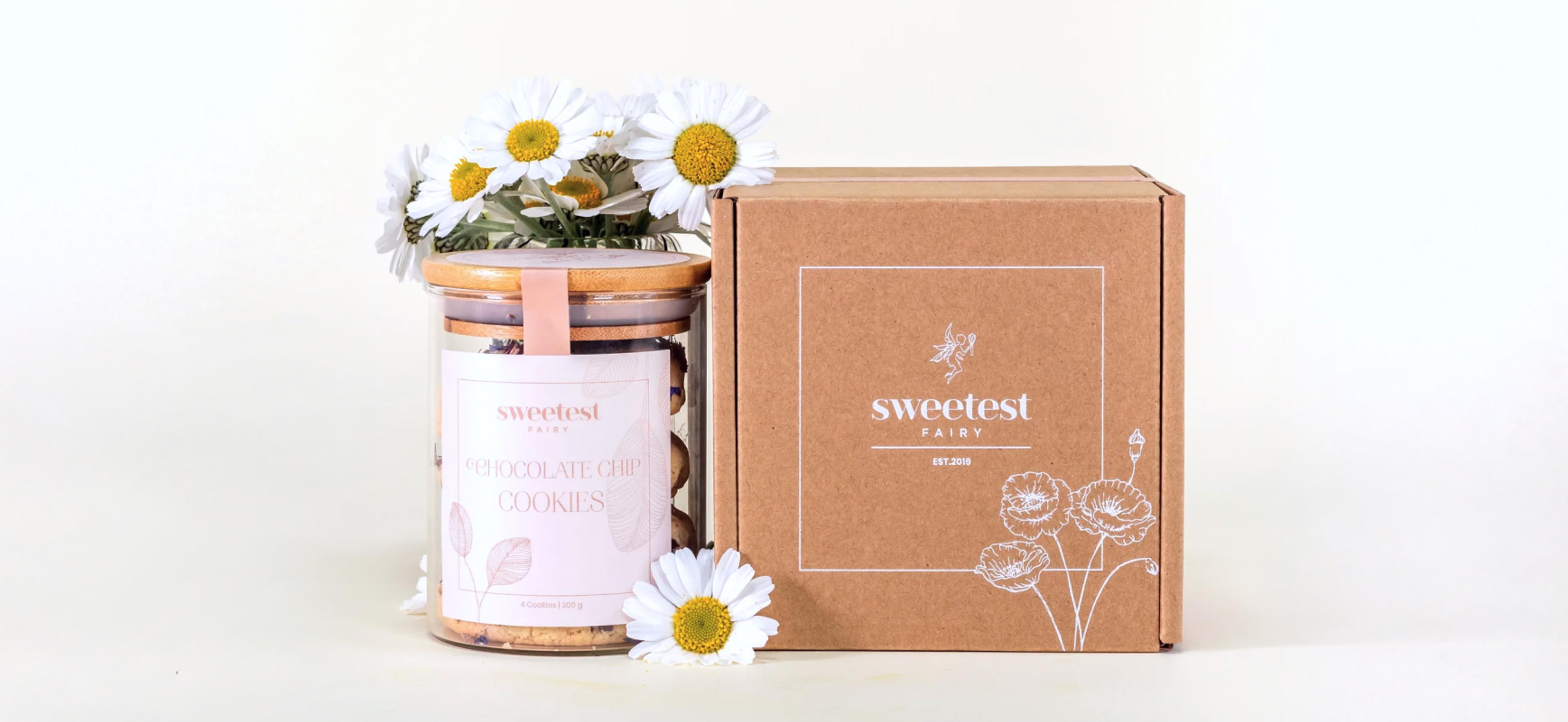 Sweetest Fairy | Sarah Frost Verpackungskonzept für Sweetest Fairy, entwickelt von Unerwartet Design. Ein harmonisches Zusammenspiel aus edlen Kuchengläsern mit filigranen Etiketten und schlichten Versandboxen für ein luxuriöses Markenerlebnis.