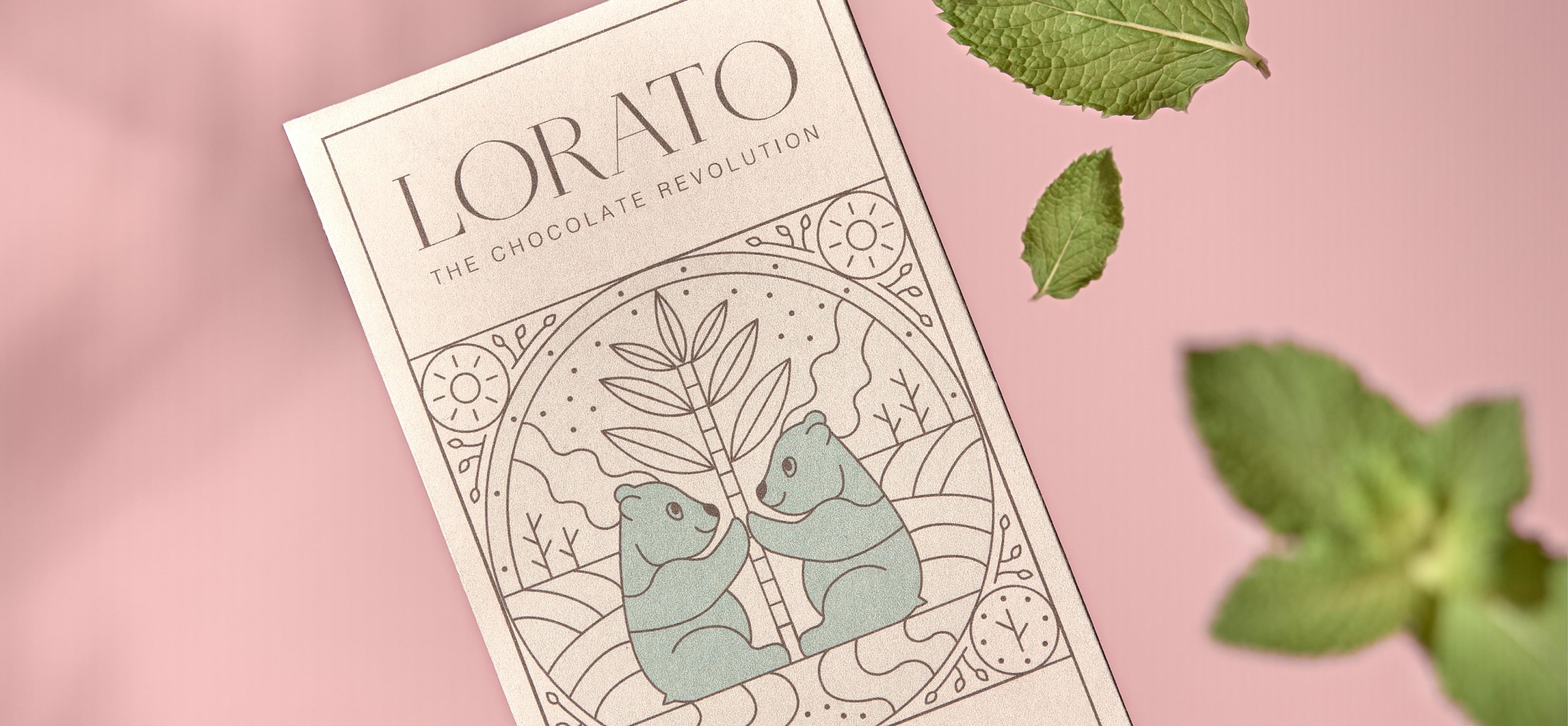 Detailansicht der Lorato-Schokoladenverpackung mit illustriertem Design von zwei Bären und einer Pflanze, vor einem rosa Hintergrund mit frischen Minzblättern – Unerwartet Design.