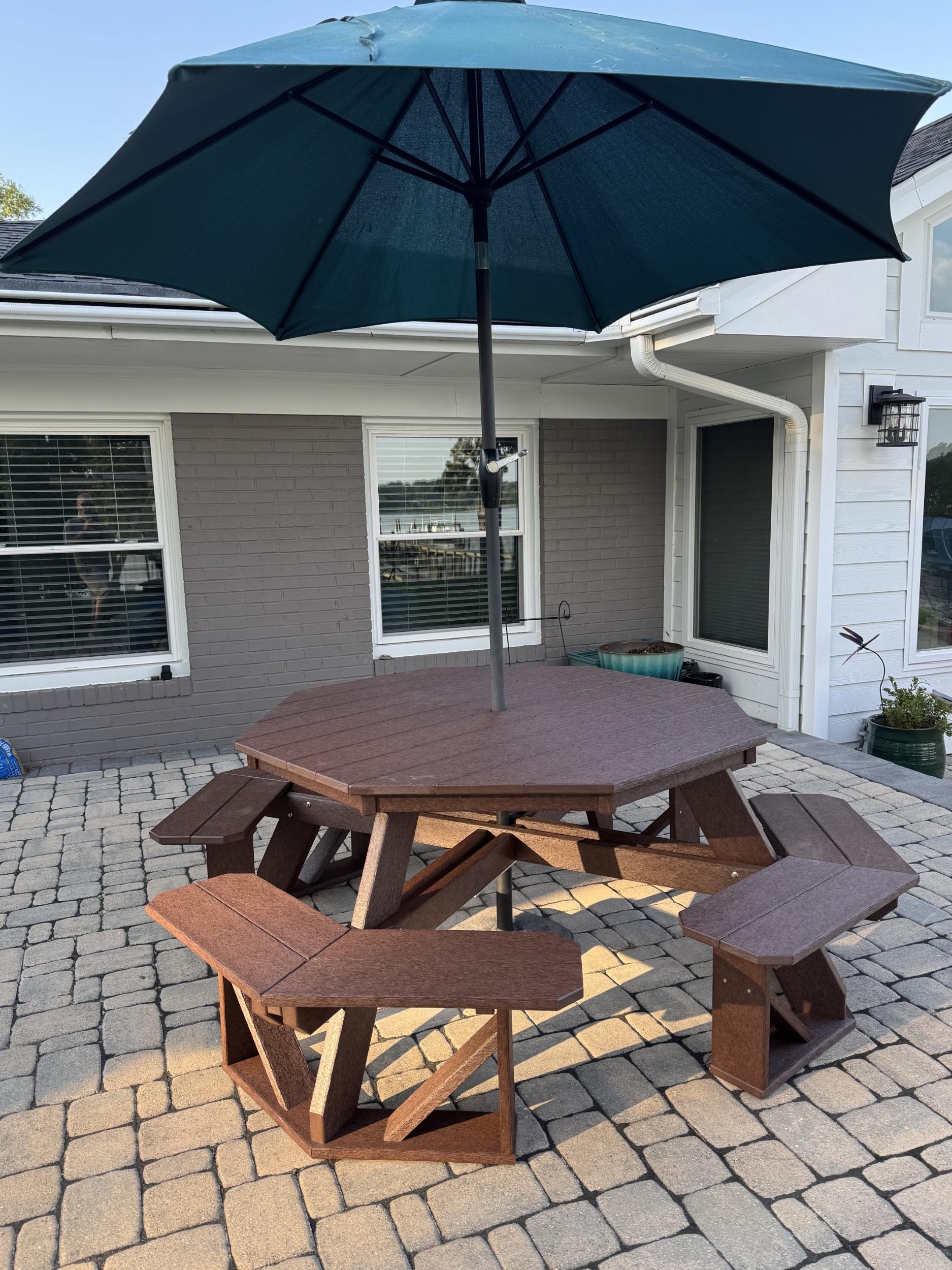 LCC-164 Heritage Octagon Picnic Table in Tudor Brown with umbrella, front view on patio