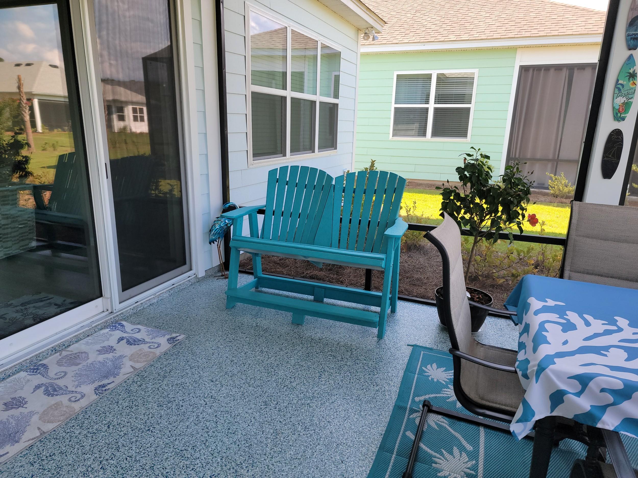 LCC-130 Heritage Double High Adirondack Chair in Aruba Blue, angled view on porch