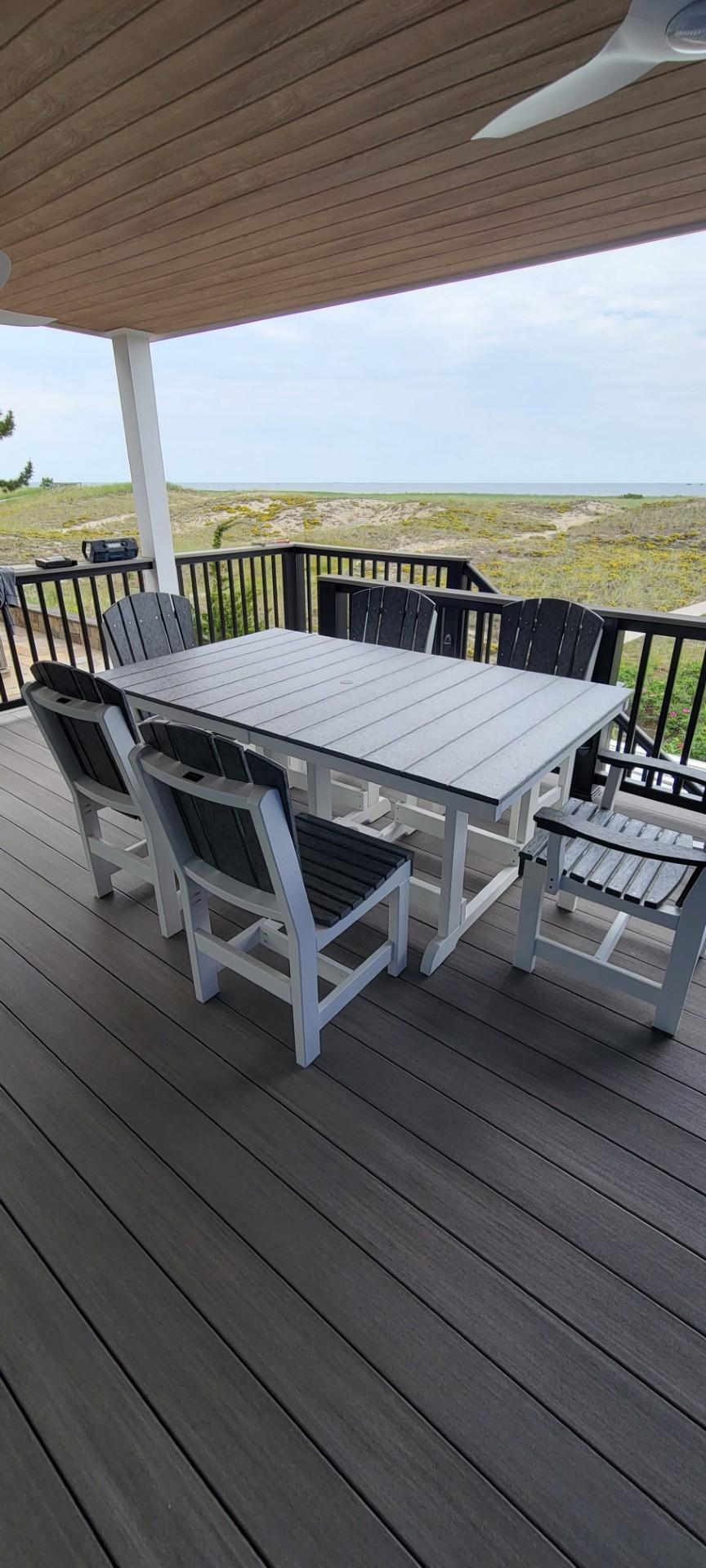LCC-188 Outdoor Dining Set with Rectangular Table and Adirondack Chairs on a deck