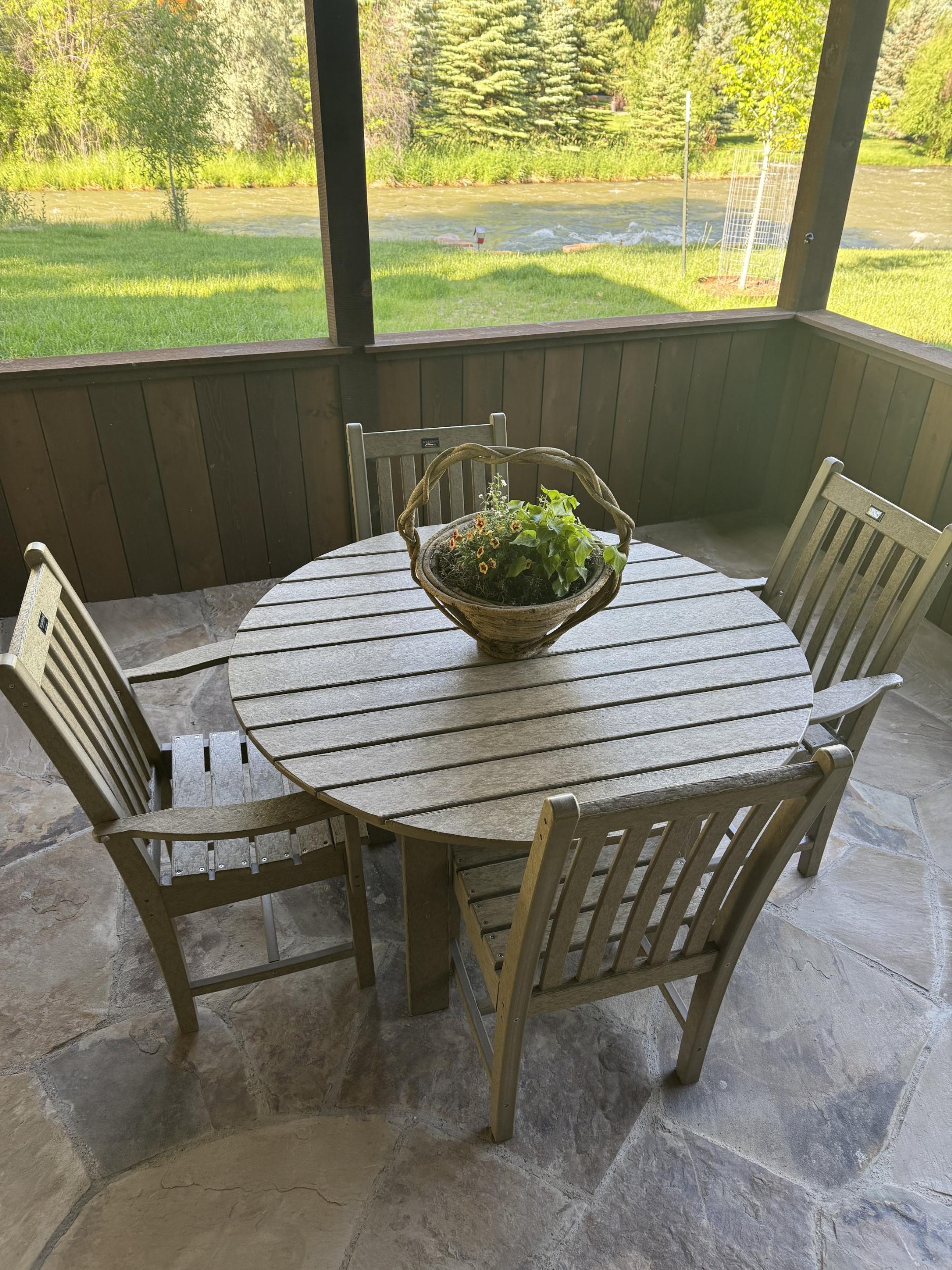 LCC-283 Round Outdoor Dining Table Set with four chairs, top view on stone patio