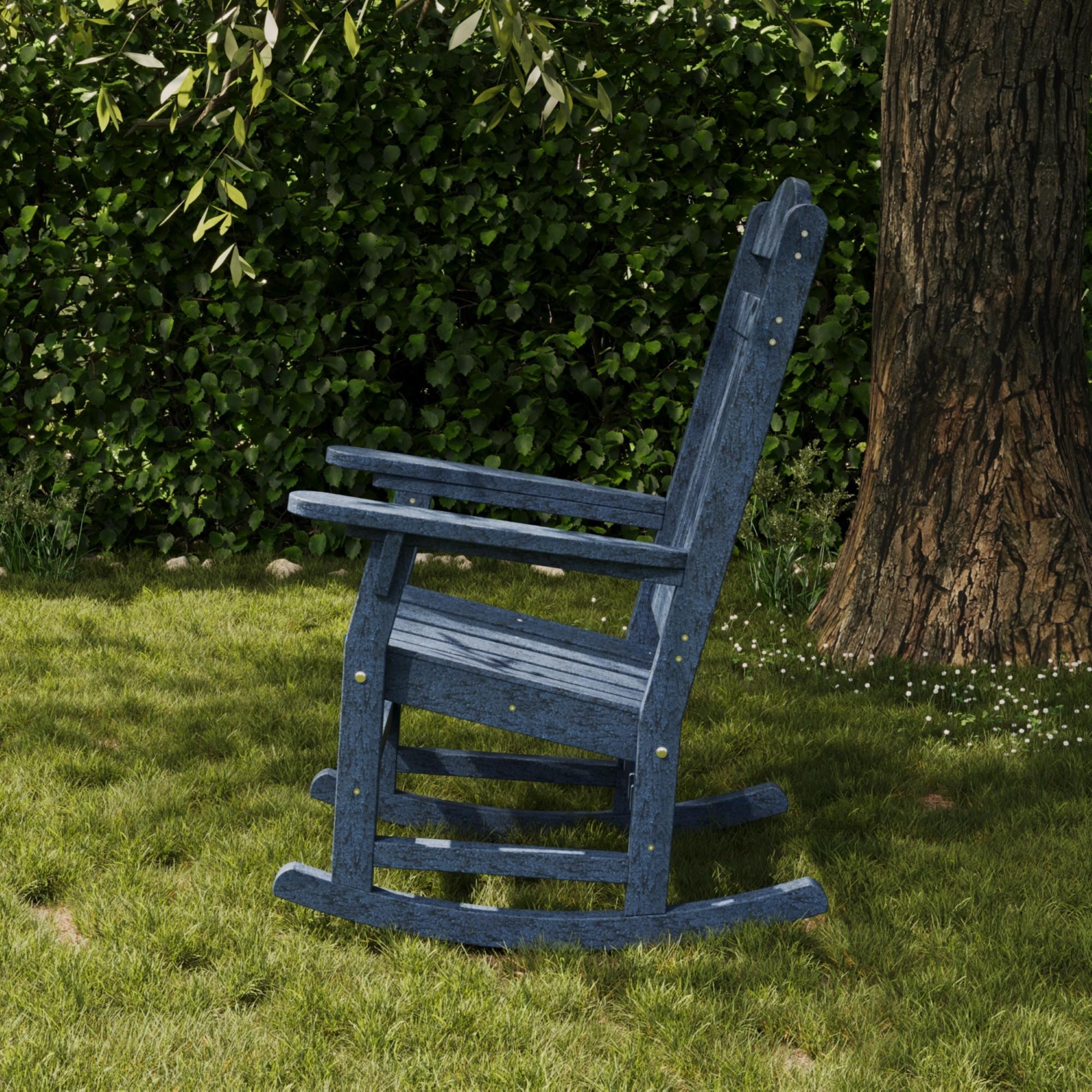 Heritage navy blue outdoor rocking chair made from durable recycled poly lumber, placed on green grass by a tree—perfect patio or garden seating for relaxing in any backyard.
