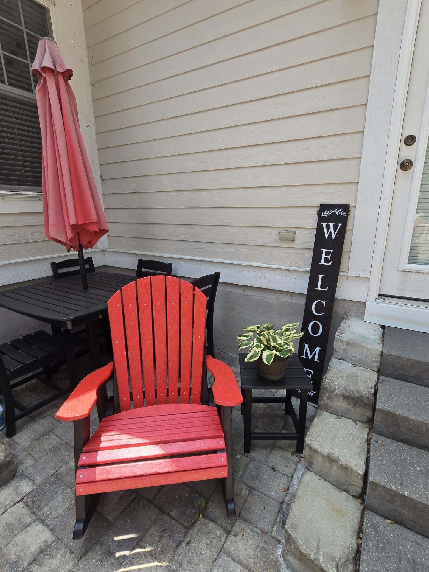 LCC-115 Heritage Adirondack Rocking Chair in Red and Black on a porch