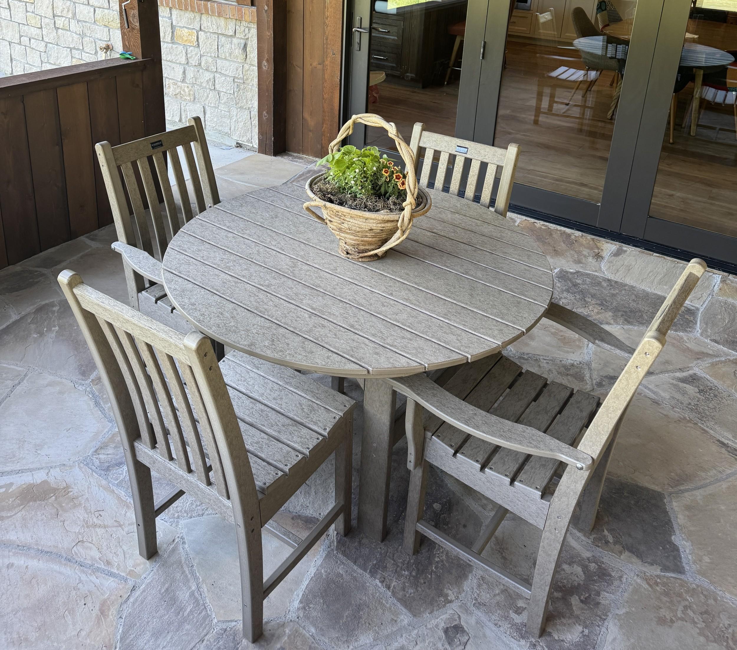 LCC-283 Round Outdoor Dining Table Set with four chairs on stone patio