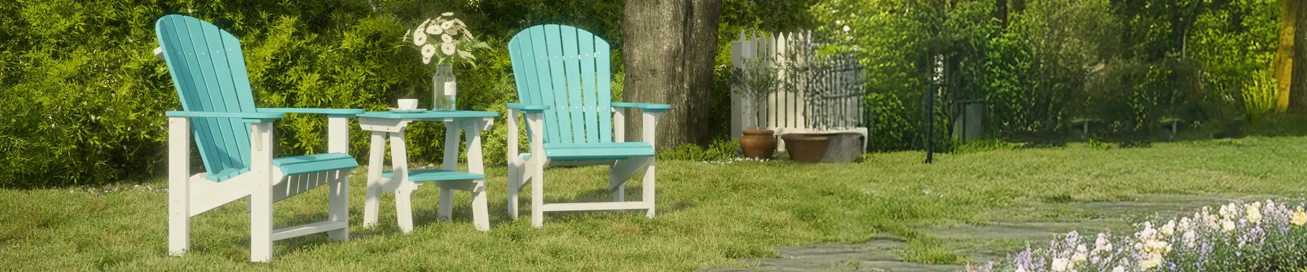 Outdoor patio set with two turquoise Adirondack chairs and table in a garden