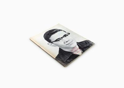 book cover with portrait of young man wearing glasses