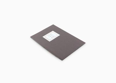 grey book cover with white card stamped on