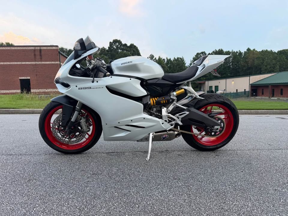 2015 Ducati 899 Panigale — left side profile with red wheels and Termignoni exhaust, parked on pavement