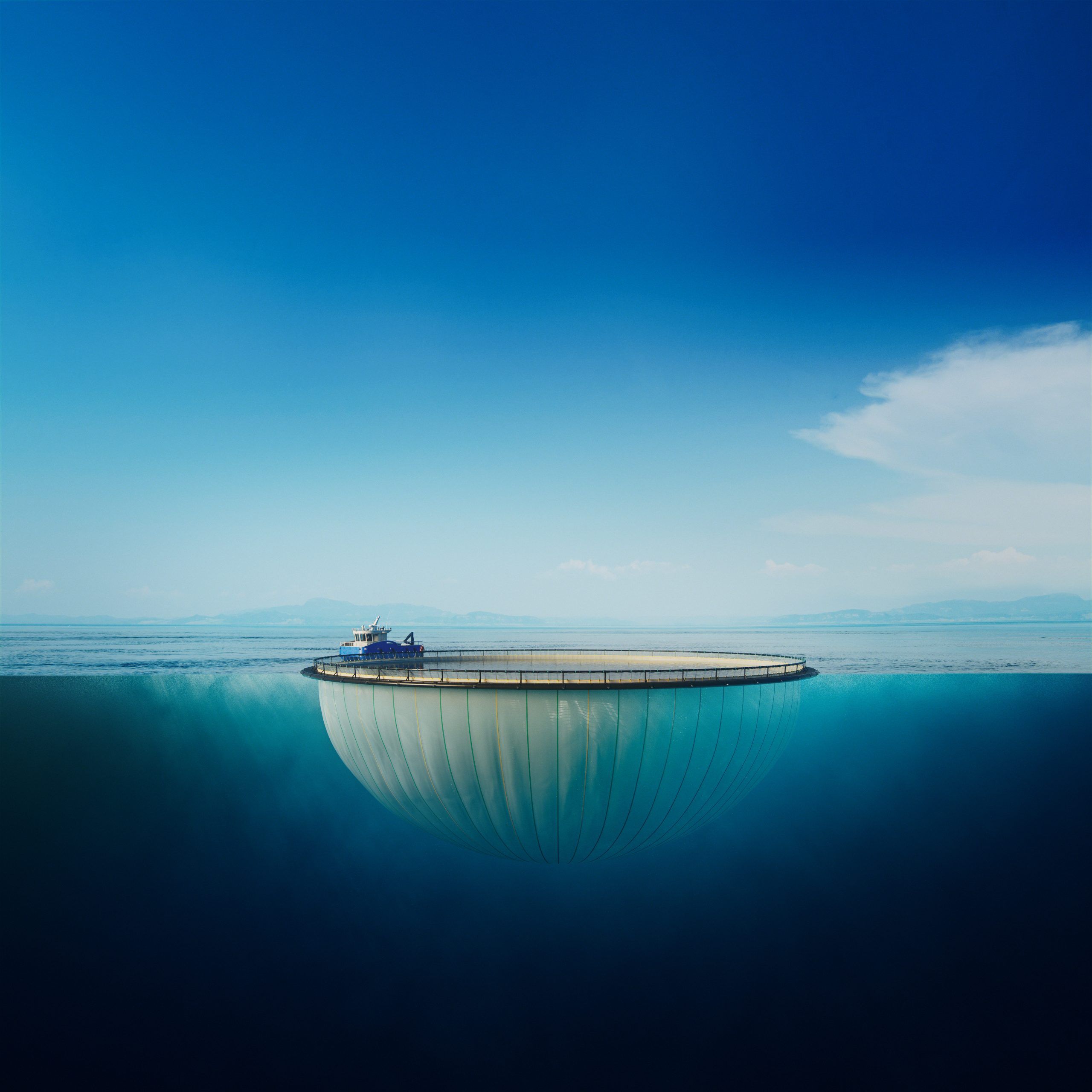 Side view of a circular delousing skirt suspended from a floating collar, showing the smooth, reinforced fabric designed to enclose the cage during delousing operations in aquaculture.
