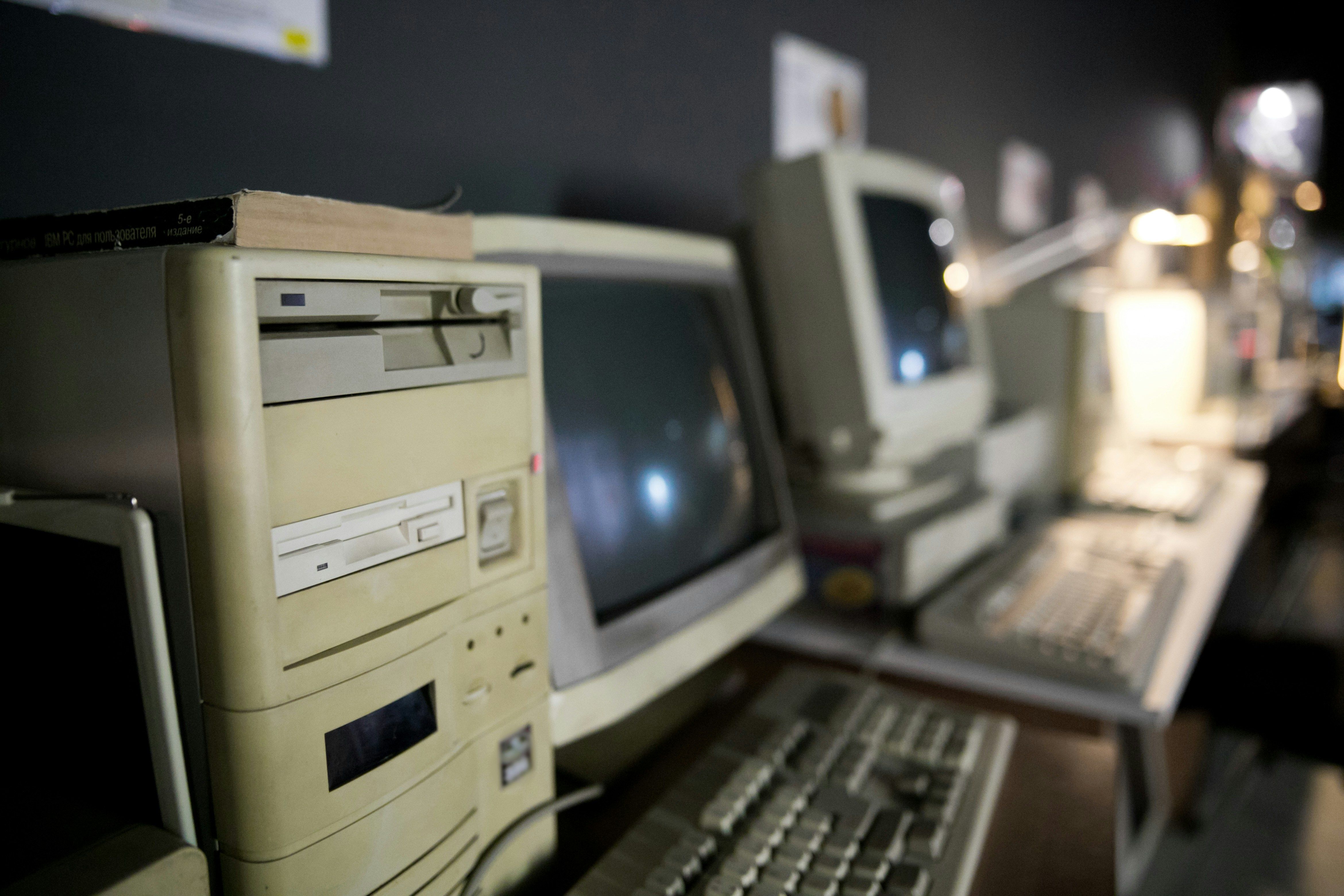 Vintage computer lab with beige desktop PCs and CRT monitors from the early 2000s constraint-driven programming era