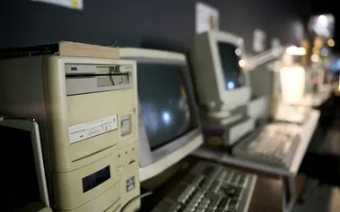 Vintage computer lab with beige desktop PCs and CRT monitors from the early 2000s constraint-driven programming era