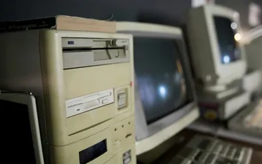 Vintage computer lab with beige desktop PCs and CRT monitors from the early 2000s constraint-driven programming era
