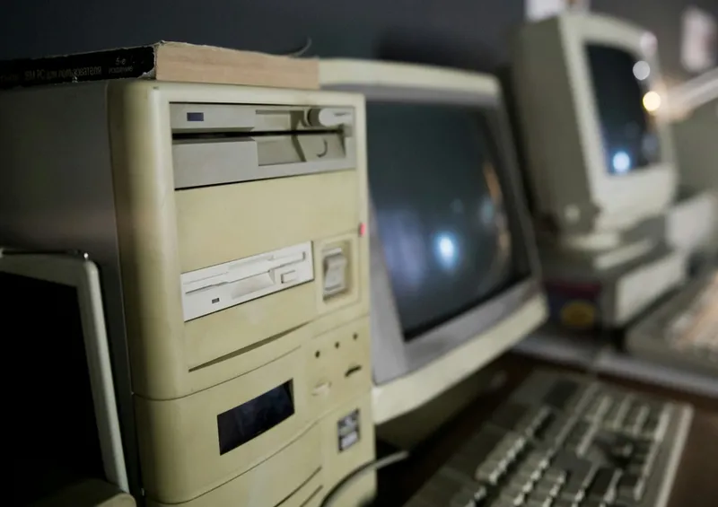 Vintage computer lab with beige desktop PCs and CRT monitors from the early 2000s constraint-driven programming era