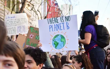 Climate protest with 'There Is No Planet B' sign, illustrating the environmental imperative driving sustainable digital transformation practices