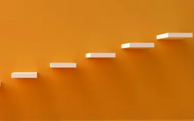 Ascending white steps on orange background illustrating management hierarchy progression