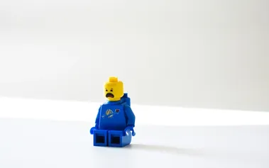 Worried LEGO character representing employees who feel they must hide their struggles at work