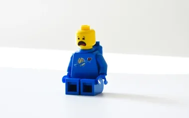 Worried LEGO character representing employees who feel they must hide their struggles at work