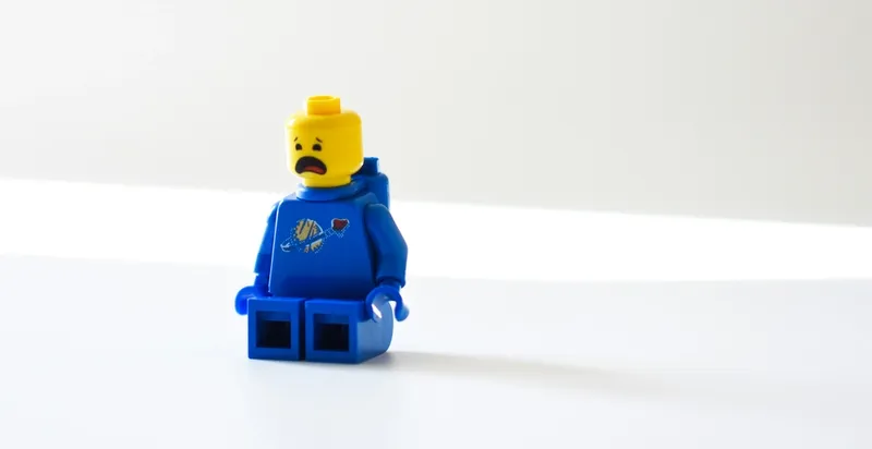 Worried LEGO character representing employees who feel they must hide their struggles at work