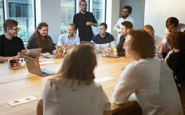 Diverse team meeting with multiple generations collaborating in modern office
