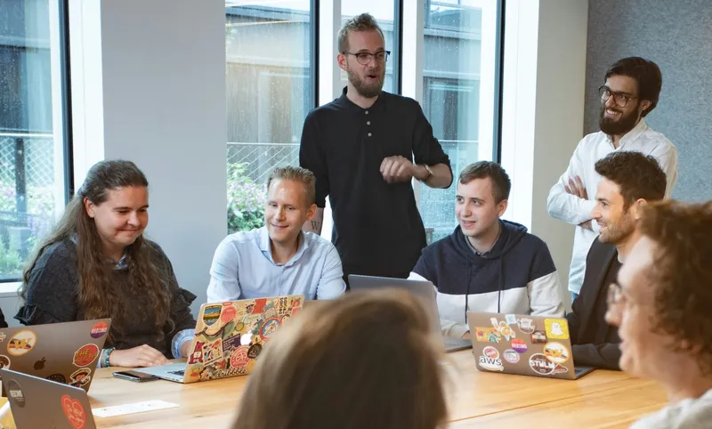 Diverse team meeting with multiple generations collaborating in modern office