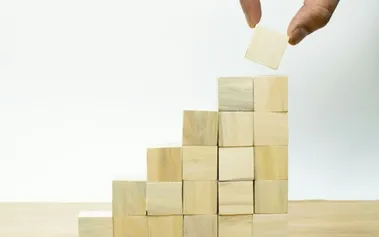 Building blocks in ascending levels representing leadership stages from startup to enterprise scale