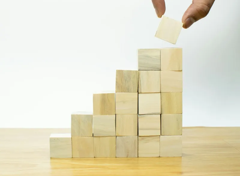 Building blocks in ascending levels representing leadership stages from startup to enterprise scale